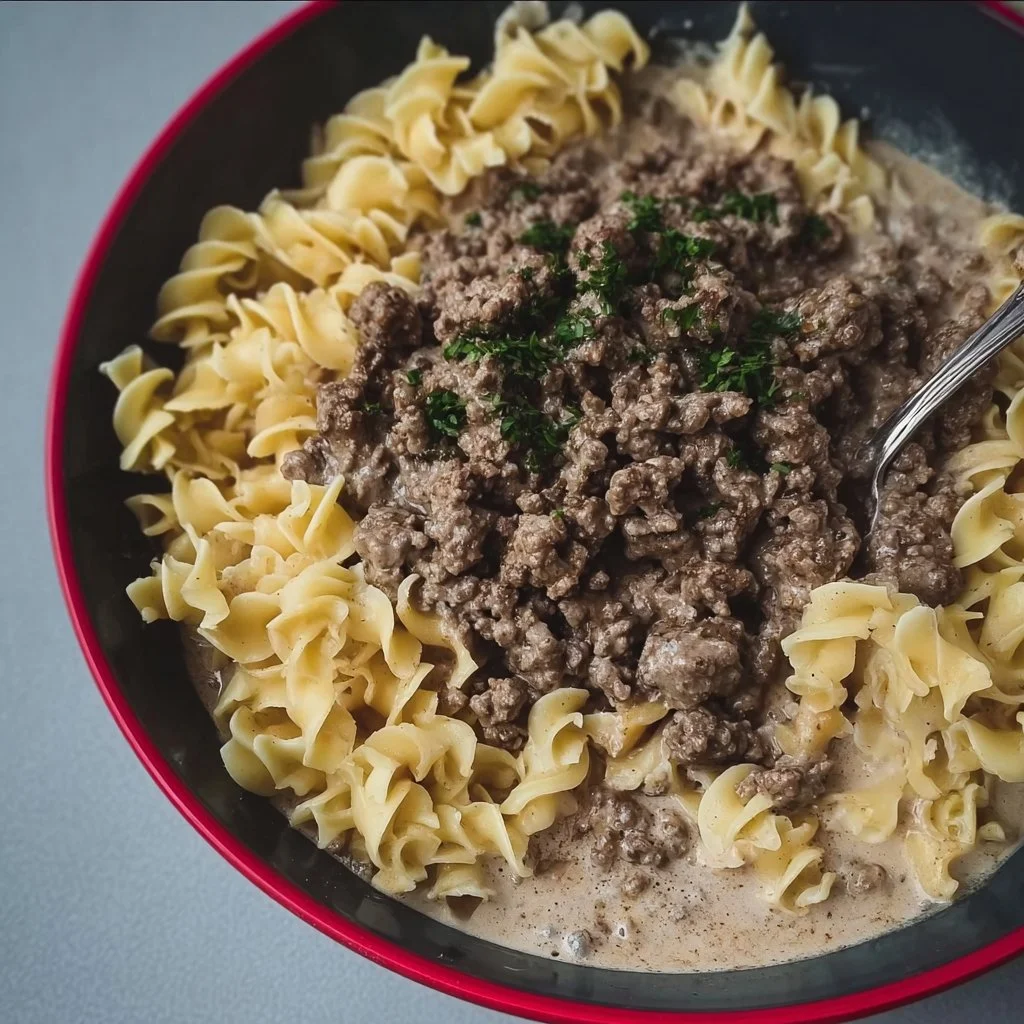 Delicious 30-minute ground beef stroganoff served with pasta and garnished.