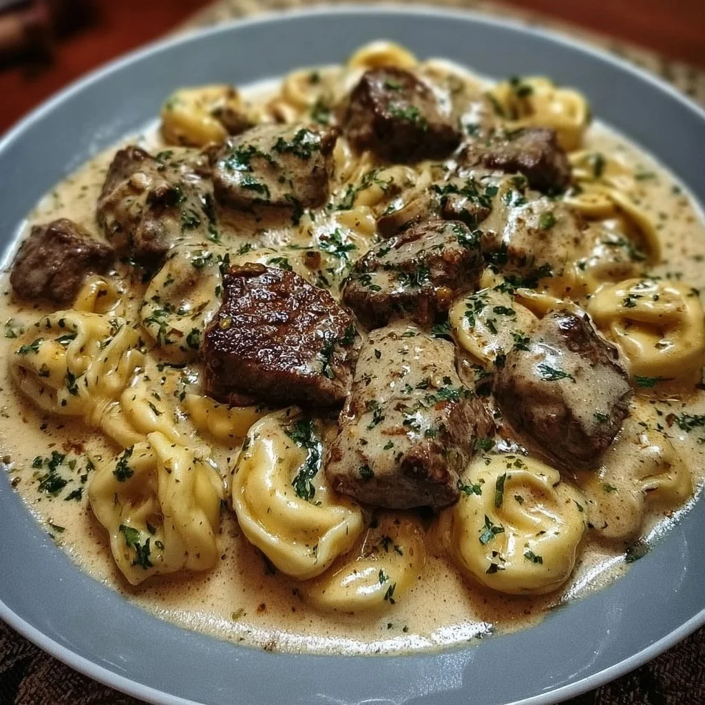 Cracked Garlic Steak Tortellini in Creamhouse Sauce served on a plate