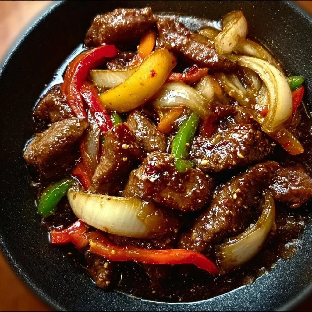 Sizzling Chinese pepper steak with onions served on a plate
