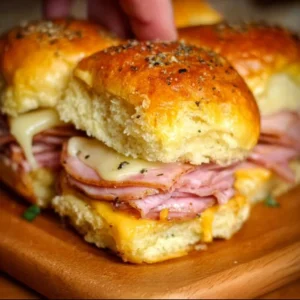 Delicious ham and cheese sliders served on a platter with garnishes
