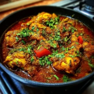 Bowl of flavorful Indian chicken curry garnished with fresh cilantro