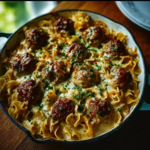 Baked Swedish meatballs with noodles and creamy sauce in a casserole dish