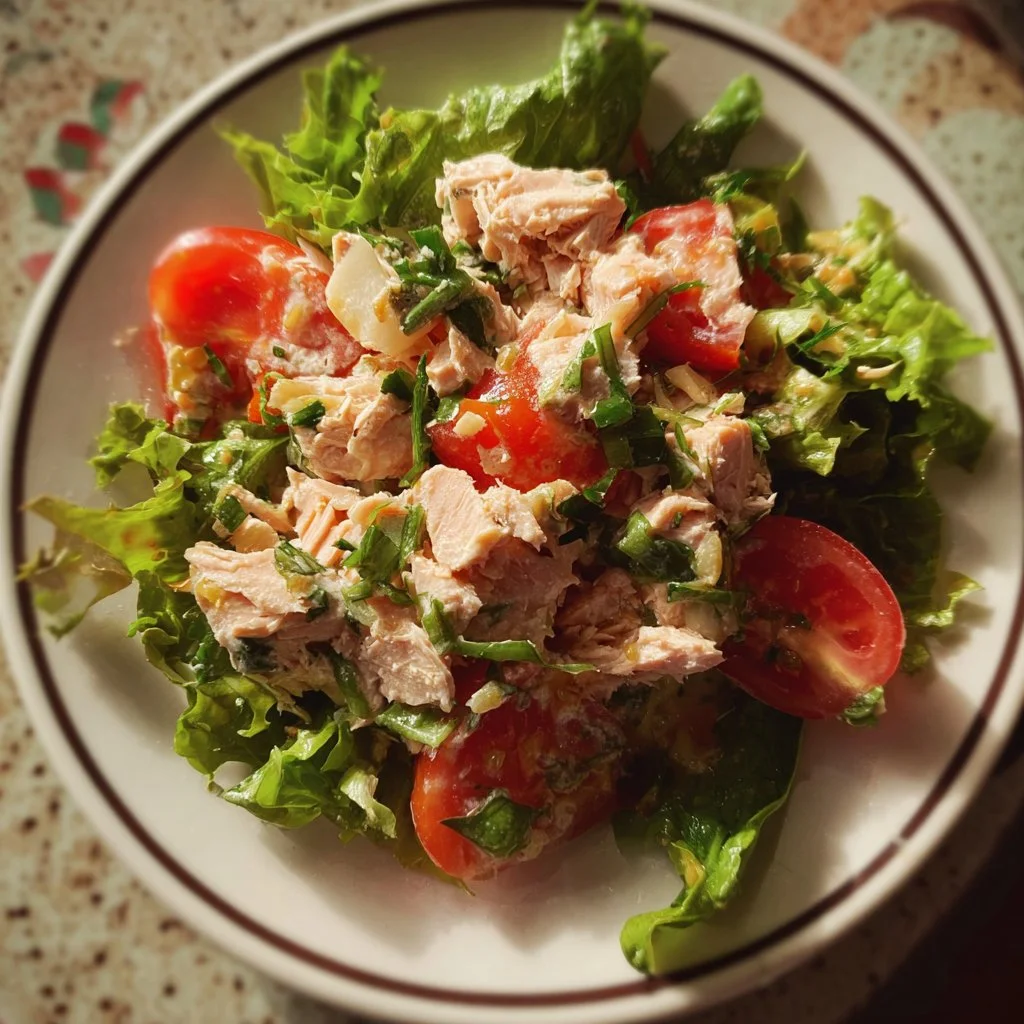 Delicious classic canned salmon salad served in a bowl with fresh ingredients.