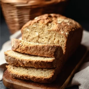 Loaf of hearty gluten free oat bread fresh out of the oven