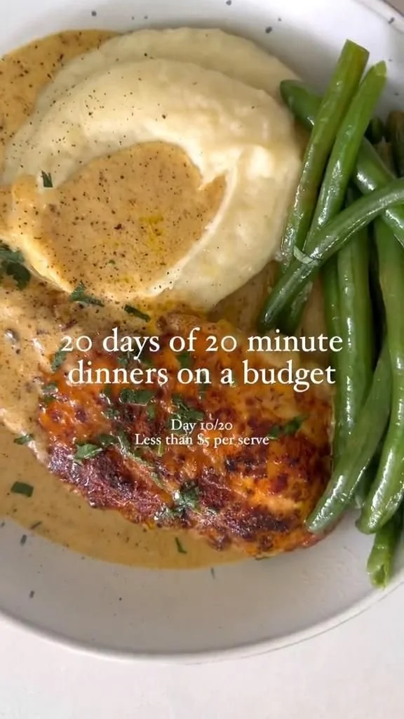 Creamy chicken schnitzel served with a side of vegetables and sauce